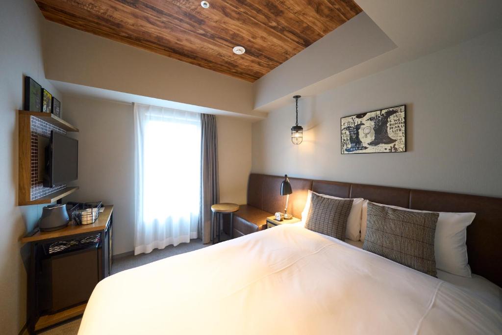 Postel nebo postele na pokoji v ubytování Hotel Resol Akihabara