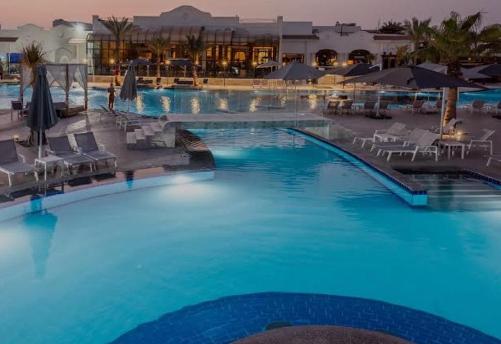 a large pool with blue water in a resort at Sharm dreams vacation club in Sharm El Sheikh