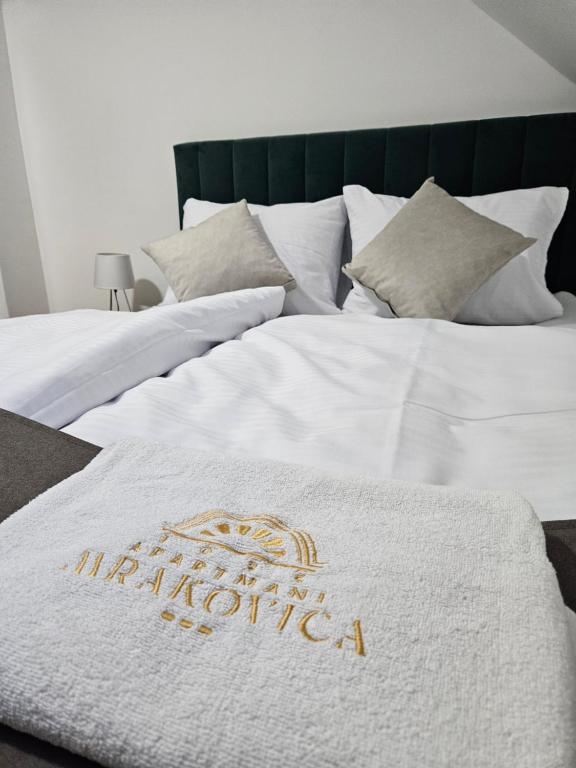 a white blanket on top of a bed at Mrakovica 1935 in Prijedor