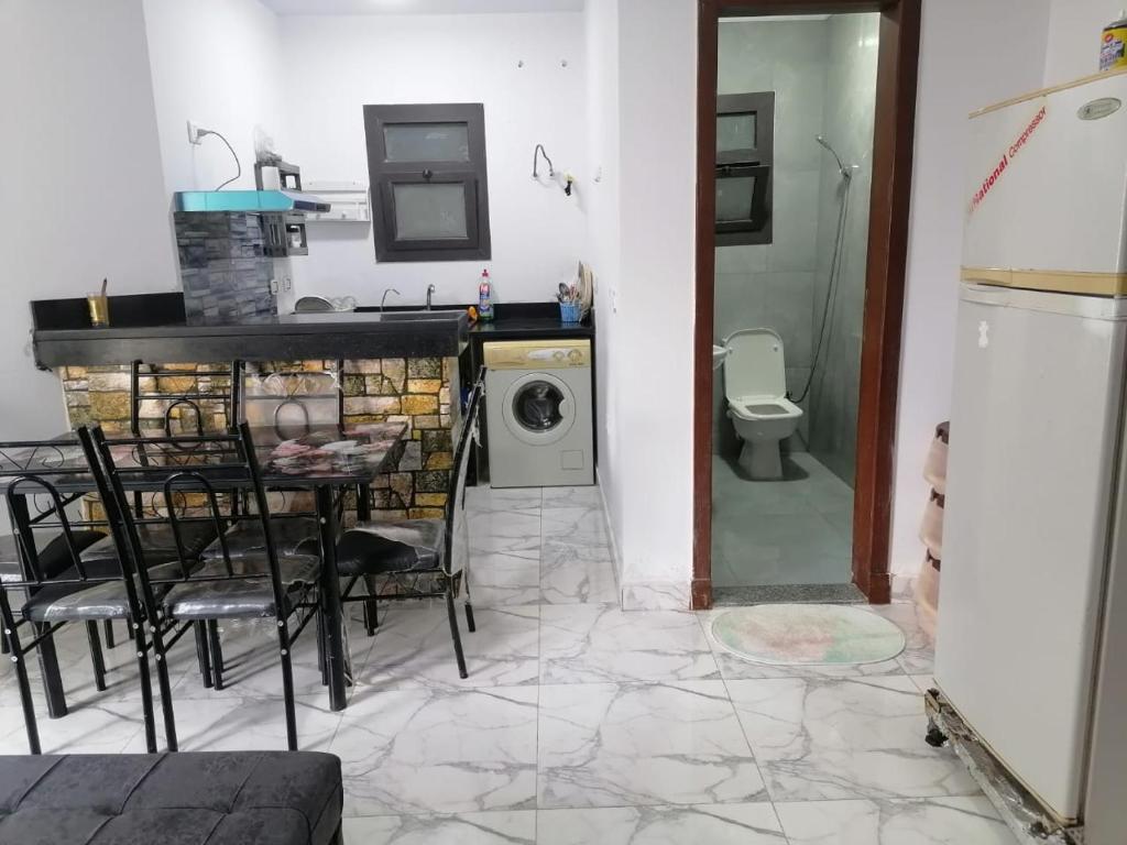 a kitchen with a table and a washing machine at شاليه غرفة ورسيبشن وحمام ومطبخ عماره 6 الدور الثاني 6232 in Port Said