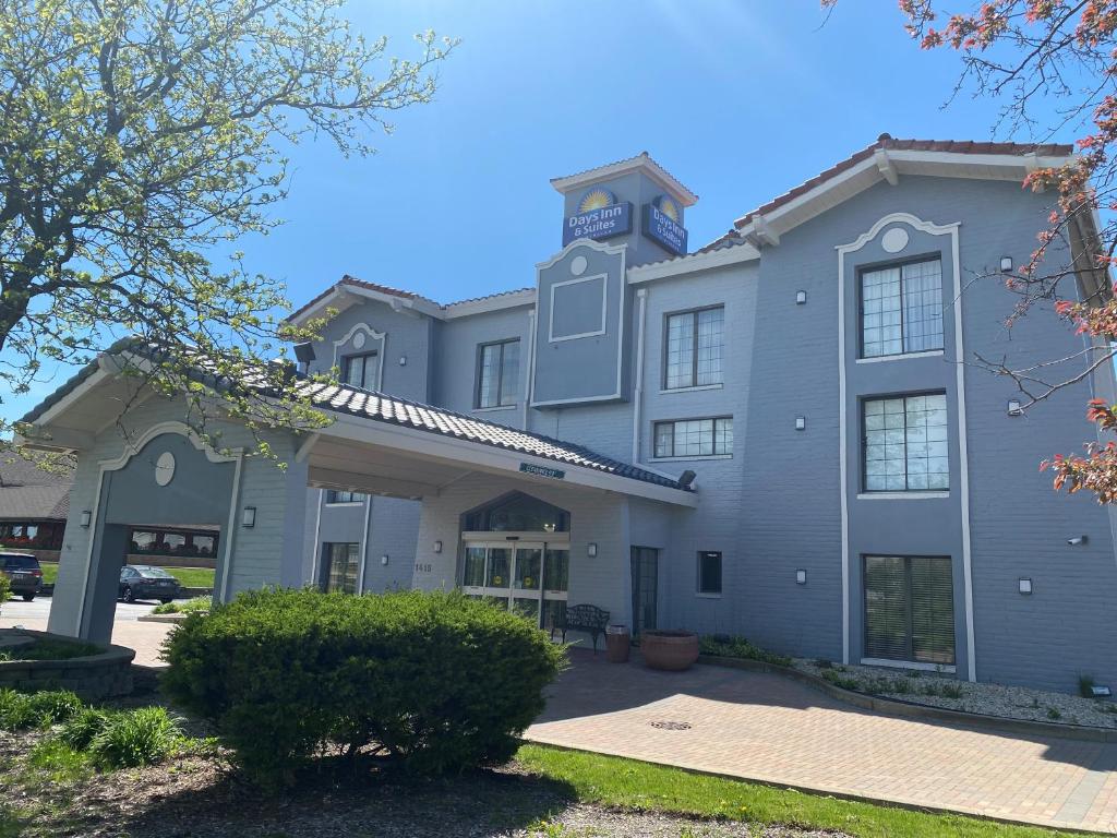 a building with a clock tower on top of it at Days Inn & Suites by Wyndham Arlington Heights in Arlington Heights