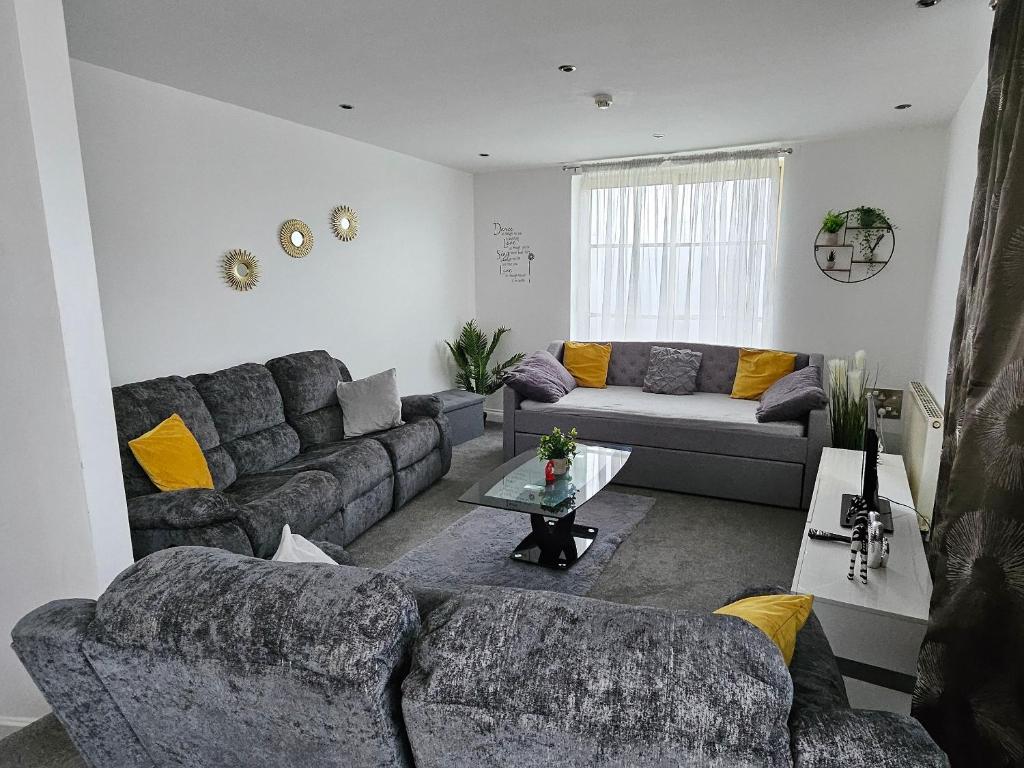 een woonkamer met een bank en een tafel bij Deluxe apartment Sleeps up to 6 in Leicester