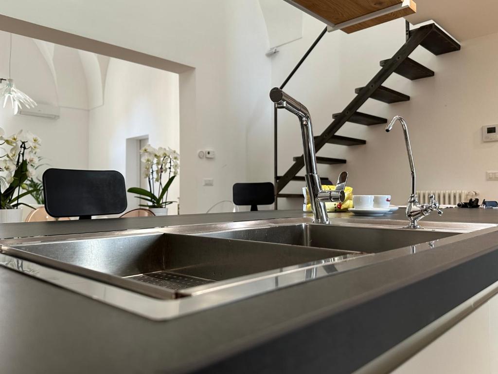 a kitchen with a stainless steel kitchen sink at Casa Guido Eco Friendly in Lecce