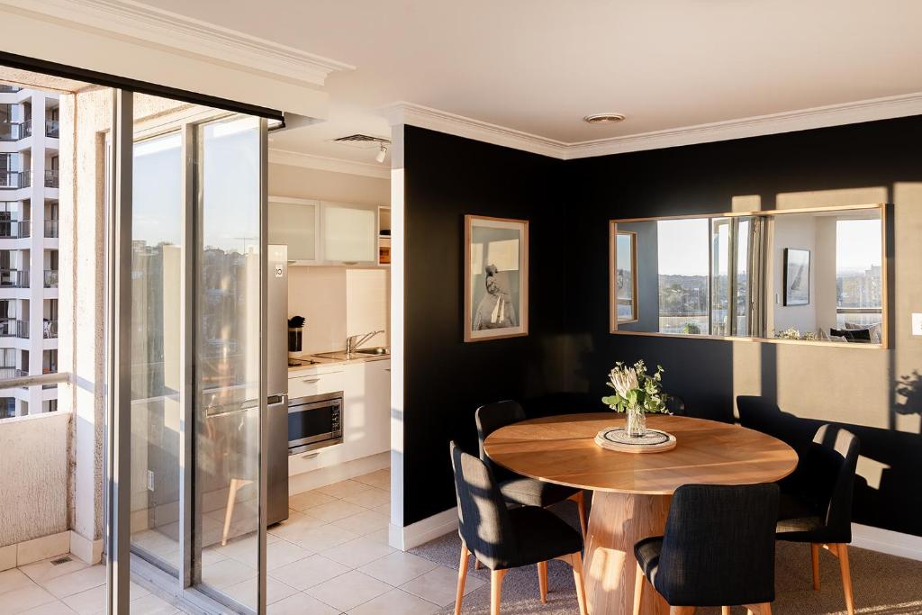 a dining room with a table and chairs at Milson Serviced Apartments in Sydney