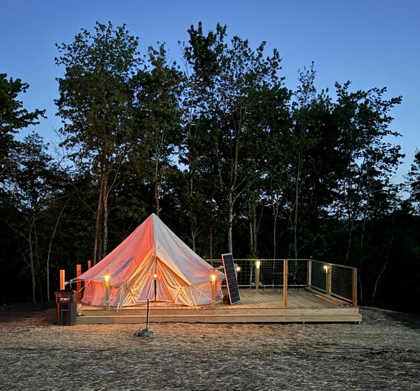 a large tent sitting on top of a wooden deck at 10 point landing Mammoth Cave Glamping Sublimity in Horse Cave