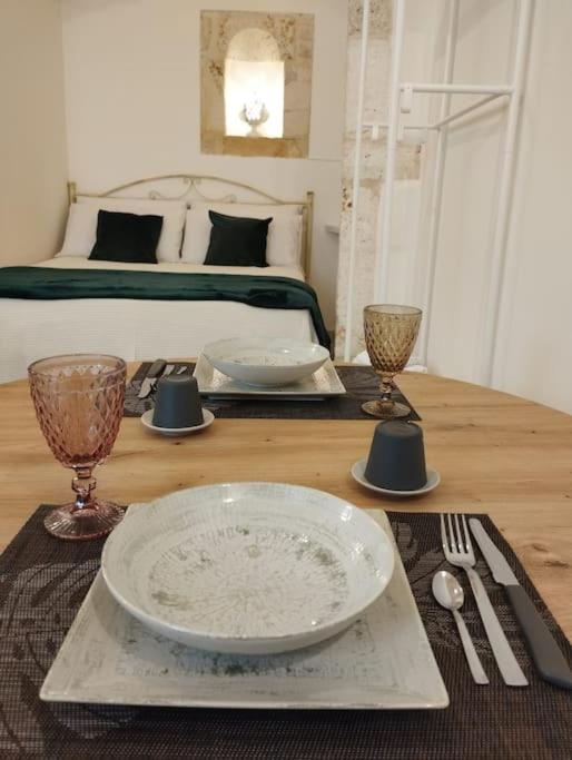 a table with a plate and a tray with a bed at Ziella Home in Ostuni