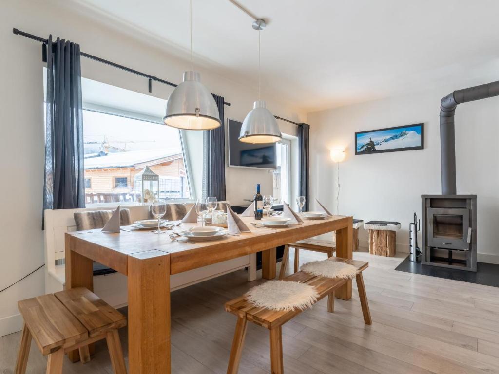 a dining room with a table and chairs and a fireplace at Brixen 3 in Brixen im Thale