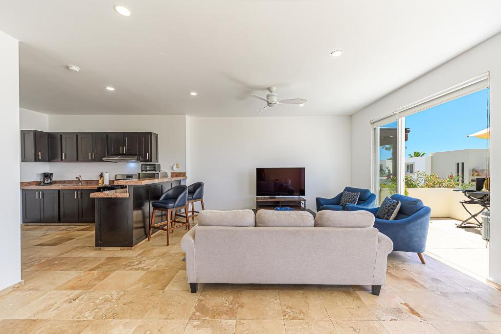 a living room with a couch and a kitchen at Cabo Villa - G3 Punta Arena - 3 Bed 2.5 Bath in Cabo San Lucas