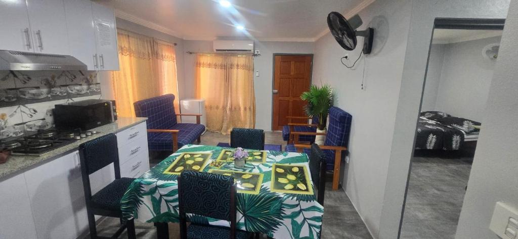 a kitchen and dining room with a table and chairs at Mount Olivet House in Suva