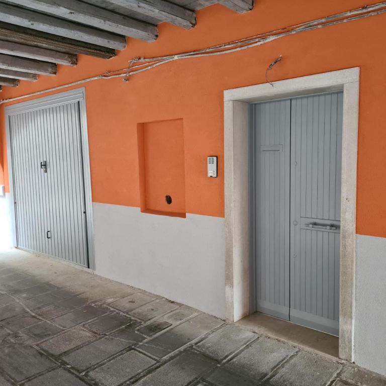 two garage doors on the side of a building at VENEZIA Beach in Chioggia