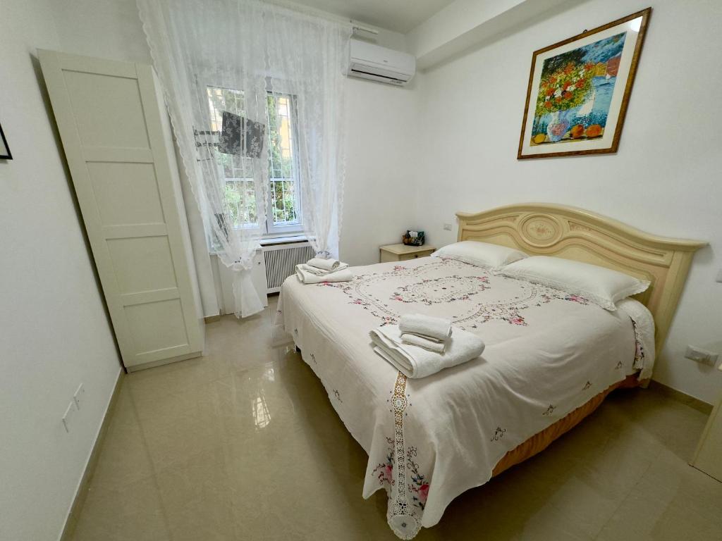 a bedroom with a bed with towels on it at Azadi Center Apartment in Rome