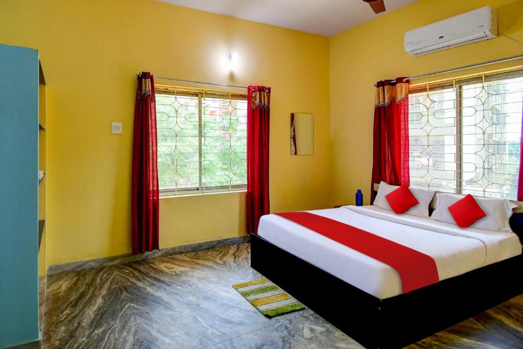 - une chambre avec un lit et des rideaux rouges dans l'établissement OYO Flagship Hotel Elite Inn, à Bhubaneswar