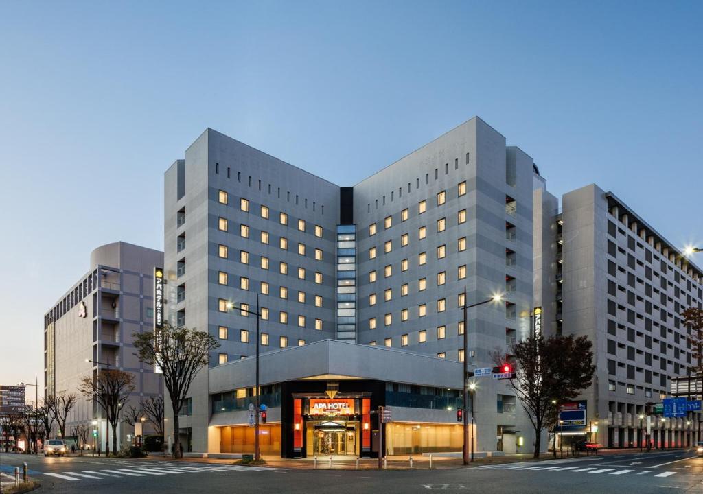 a large building on a city street at night at APA Hotel Kokura Ekimae in Kitakyushu