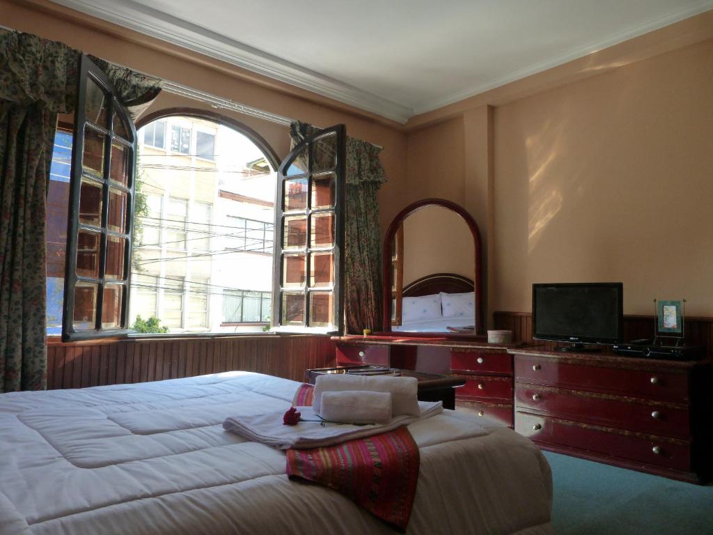 Un dormitorio con una cama grande y una ventana. en Piacere Hotel, en La Paz