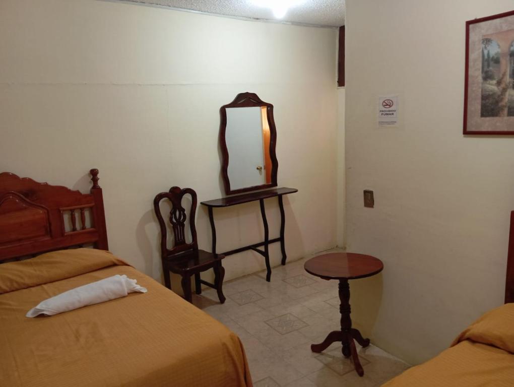 Postel nebo postele na pokoji v ubytování Hotel Juarez