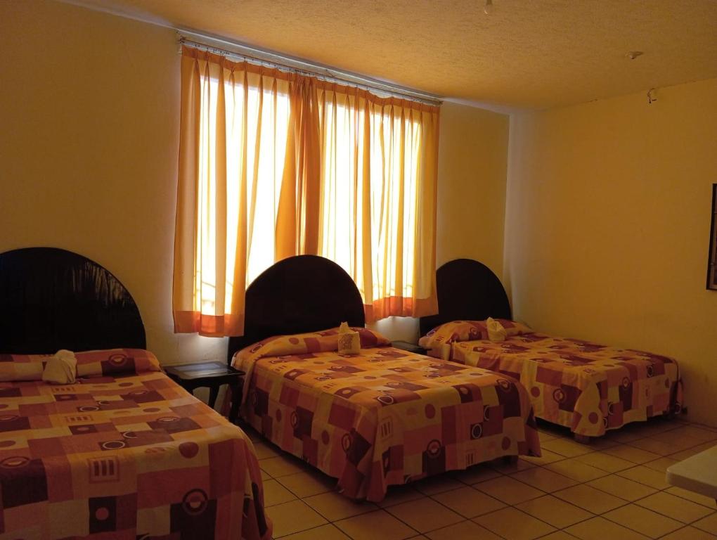 Postel nebo postele na pokoji v ubytování Hotel Juarez