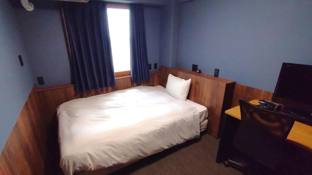 Postel nebo postele na pokoji v ubytování Handa Station Hotel