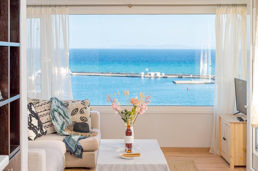 a living room with a view of the ocean at Endless Blue in Pythagoreio