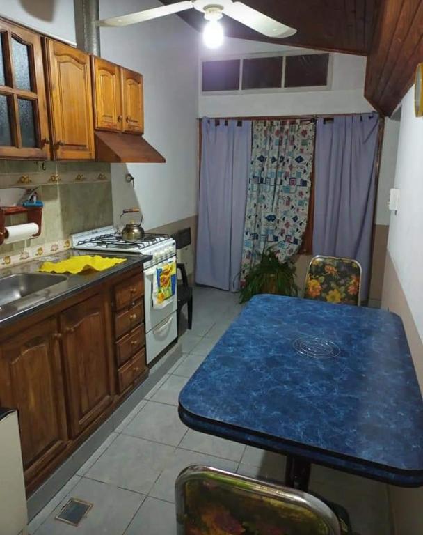 a kitchen with a blue table in a kitchen at Buen Descanso in Malargüe