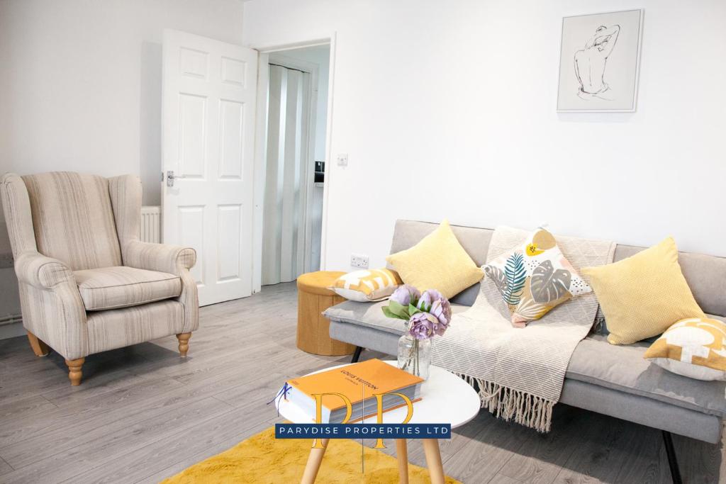 a living room with a couch and a chair at The Knutton House - By Parydise Properties - Perfect for Leisure or Business Stays- Sleeps up to 7 - Stoke on Trent in Newcastle under Lyme