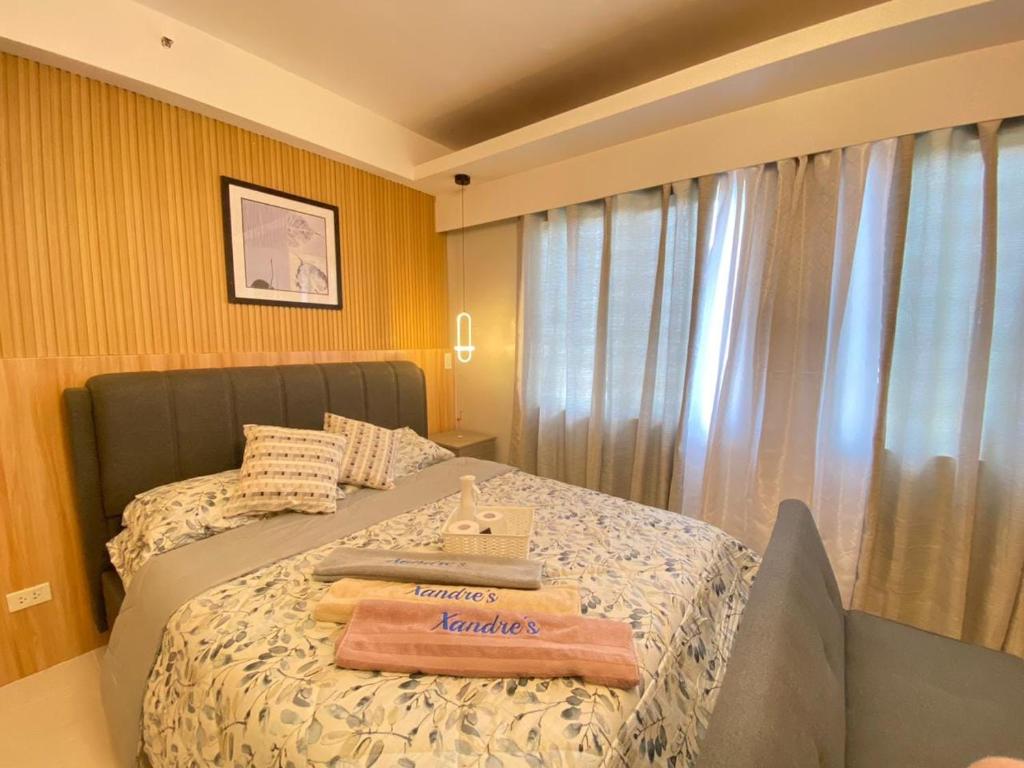 a bedroom with a bed with towels on it at 7C - Majorca Camella Manors in Bacolod