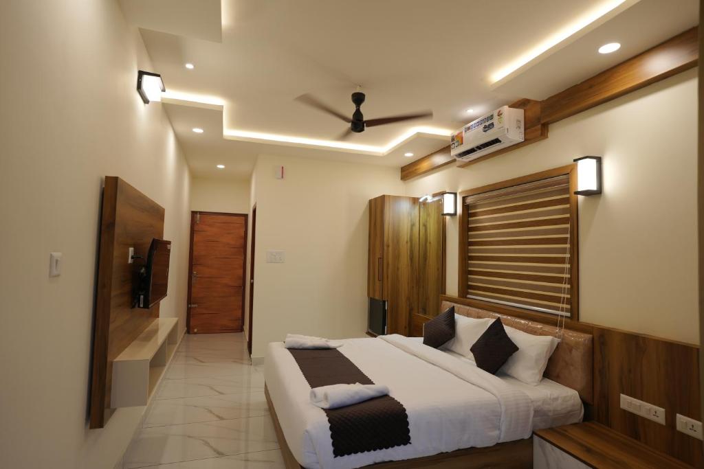 a bedroom with a large bed and a bathroom at M!steria Inn near Banasura sagar in Wayanad