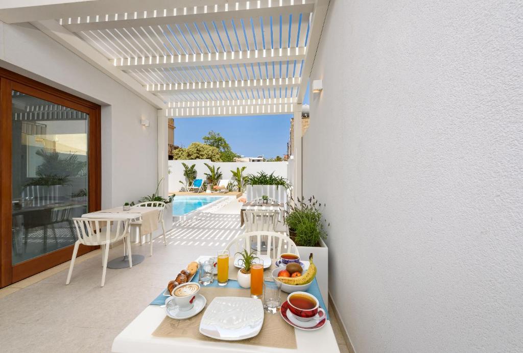 a tray of food on a table on a balcony at Andromeda Hotel in San Vito lo Capo