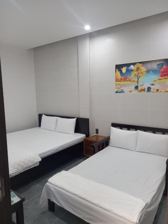 Postel nebo postele na pokoji v ubytování Hung Thinh Motel