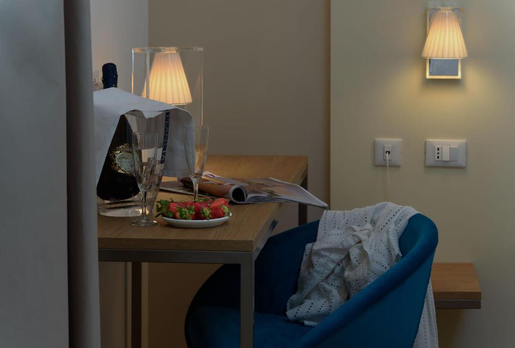 a room with a table with a bowl of fruit on it at Andromeda Hotel in San Vito lo Capo