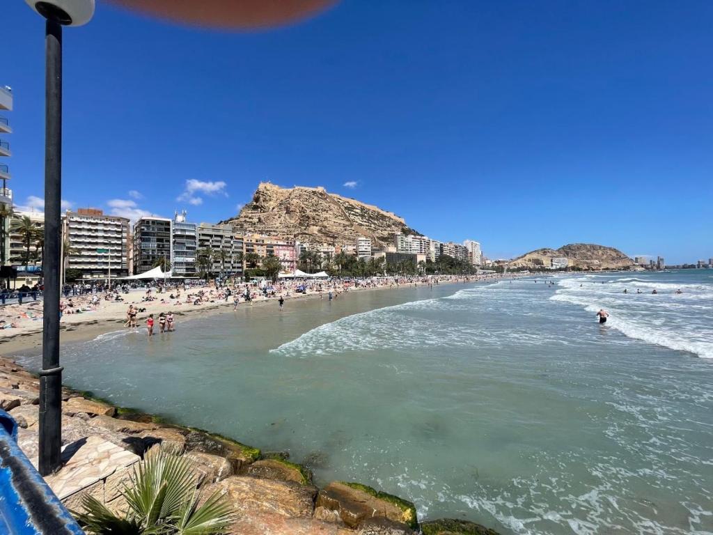 a beach with a bunch of people in the water at Home S&F- Algorfa in Algorfa