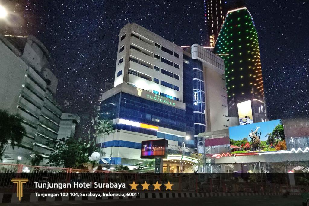 a building in a city at night at Tunjungan Hotel in Surabaya