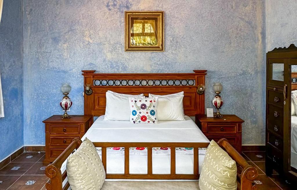 Postel nebo postele na pokoji v ubytování Casa Vicenta Izamal