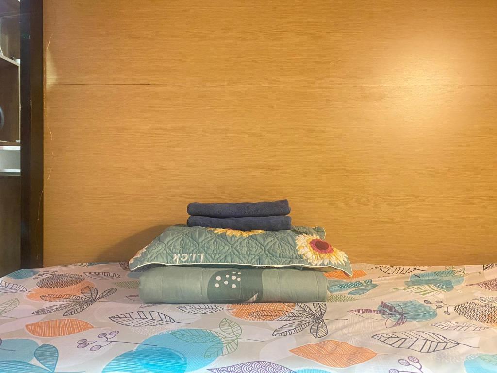 a bed with two pillows on top of it at Start House DORM Walk 5 Minutes to the Airport in Ho Chi Minh City