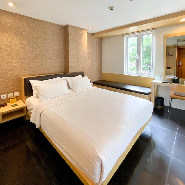 Postel nebo postele na pokoji v ubytování M Hotel