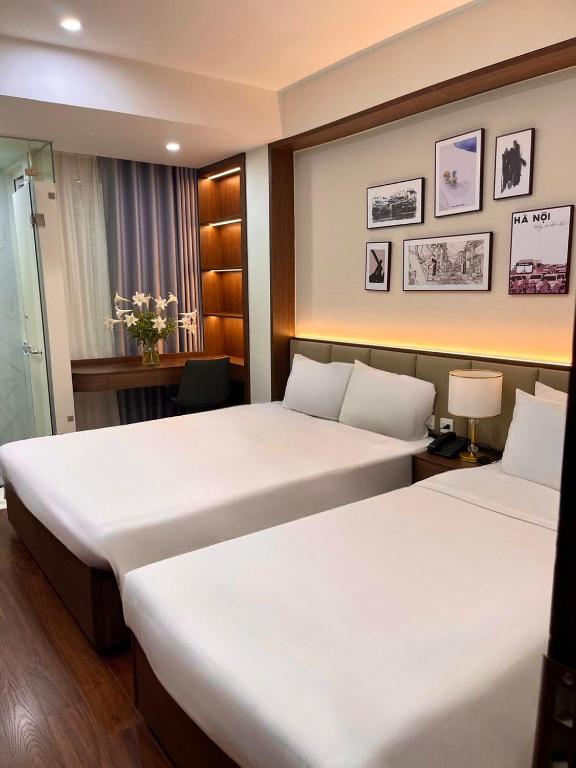 Postel nebo postele na pokoji v ubytování The Cosy Inn Hanoi