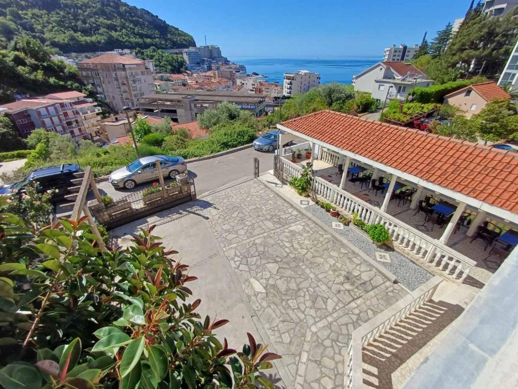 arial view of a city with a building and the ocean at Guesthouse Vila Tamburic in Becici