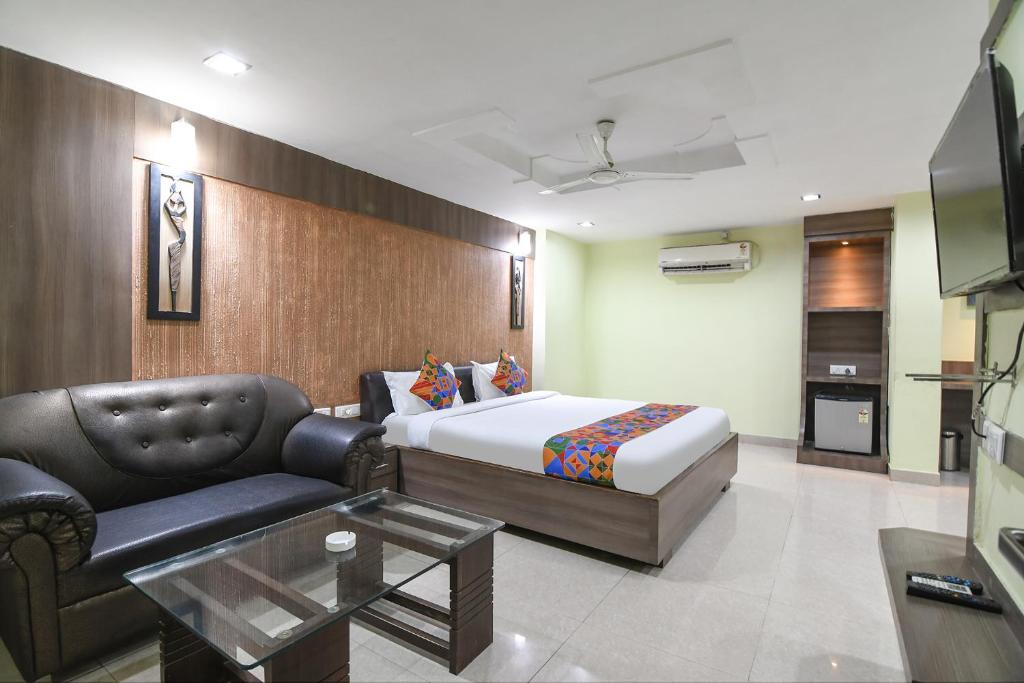 a hotel room with a bed and a couch at FabHotel Raj Residency II in Rānchī