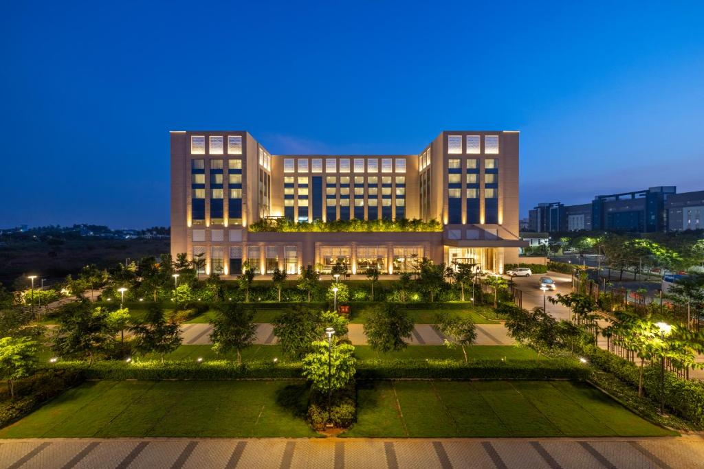 a large building with a park in front of it at Grand Madurai by GRT Hotels in Madurai