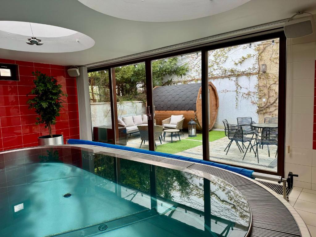 a swimming pool in a house with a view of a patio at Retro Villa Prague 700sqm Indoor-Pool, Sauna, BBQ, table soccer in Prague