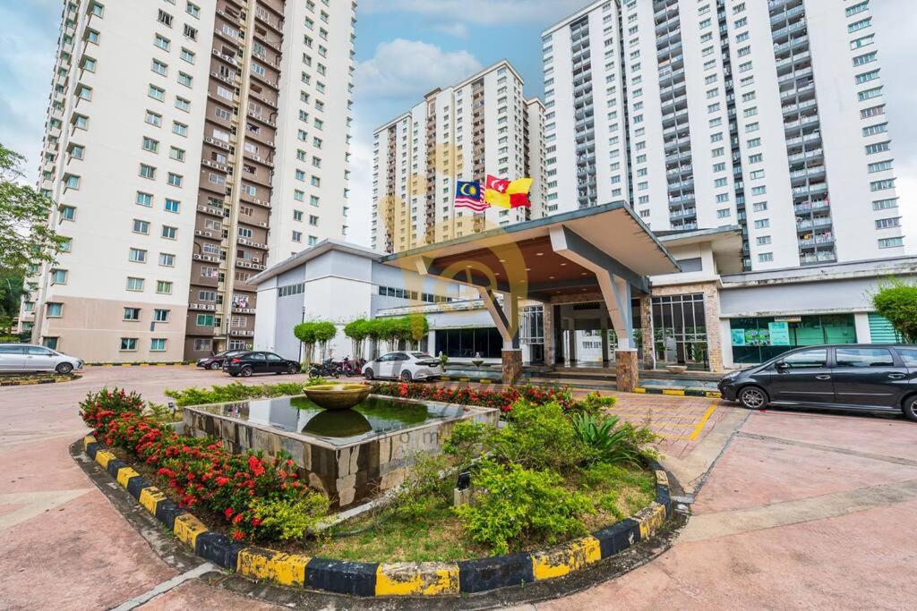 a building with a fountain in the middle of a city at Cozy Resort-Feel 3Bedroom-BBQ, Pool, Netflix 10pax in Seri Kembangan
