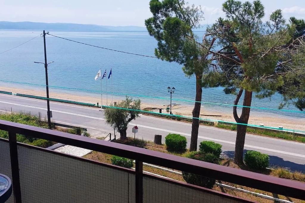 a view of the beach from the balcony of a apartment at Sun & Sea : Malaki Seaside in Malaki