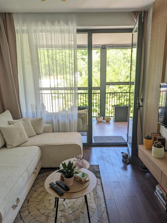 a living room with a couch and a table at 2 Sweet Renew in Rogača