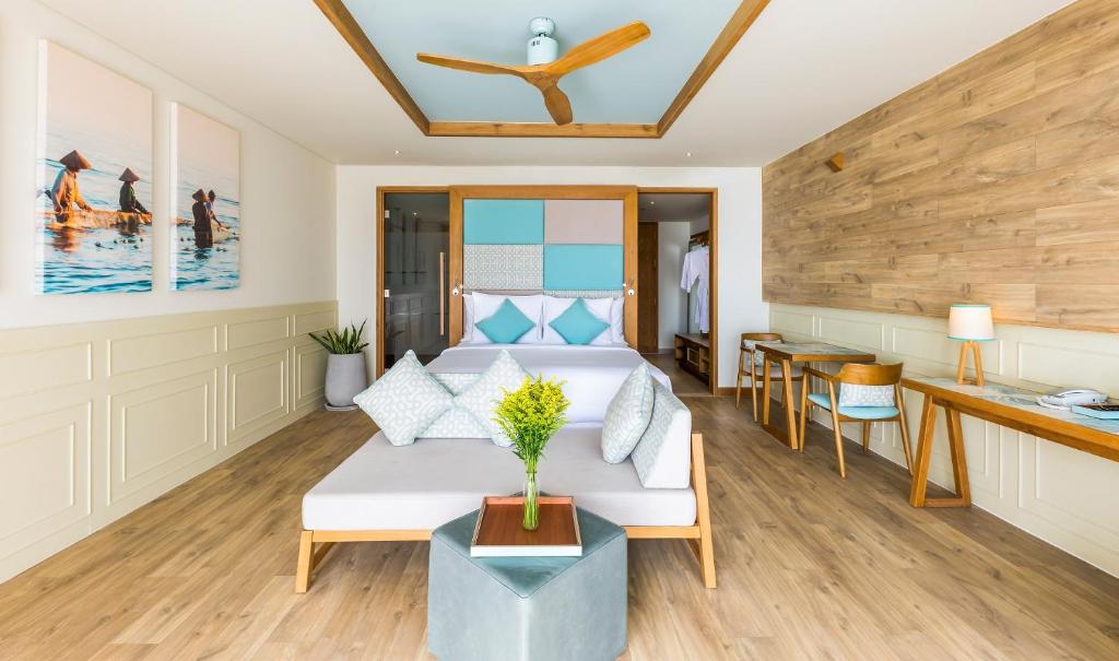a living room with a couch and a table at Fusion Suites Vung Tau in Vung Tau