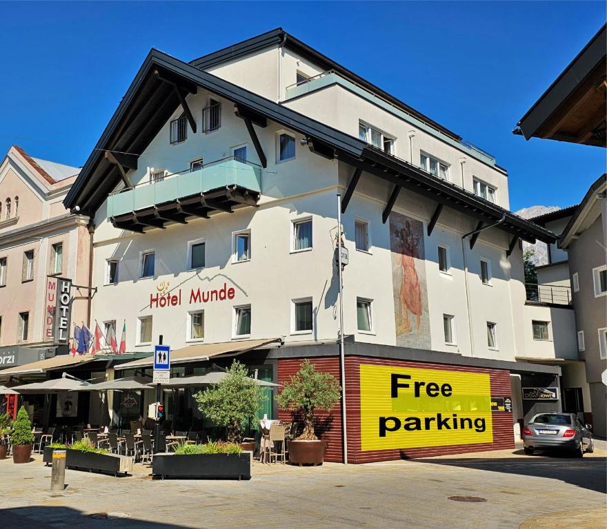 a hotel with a free parking sign in front of it at Hotel Munde in Telfs