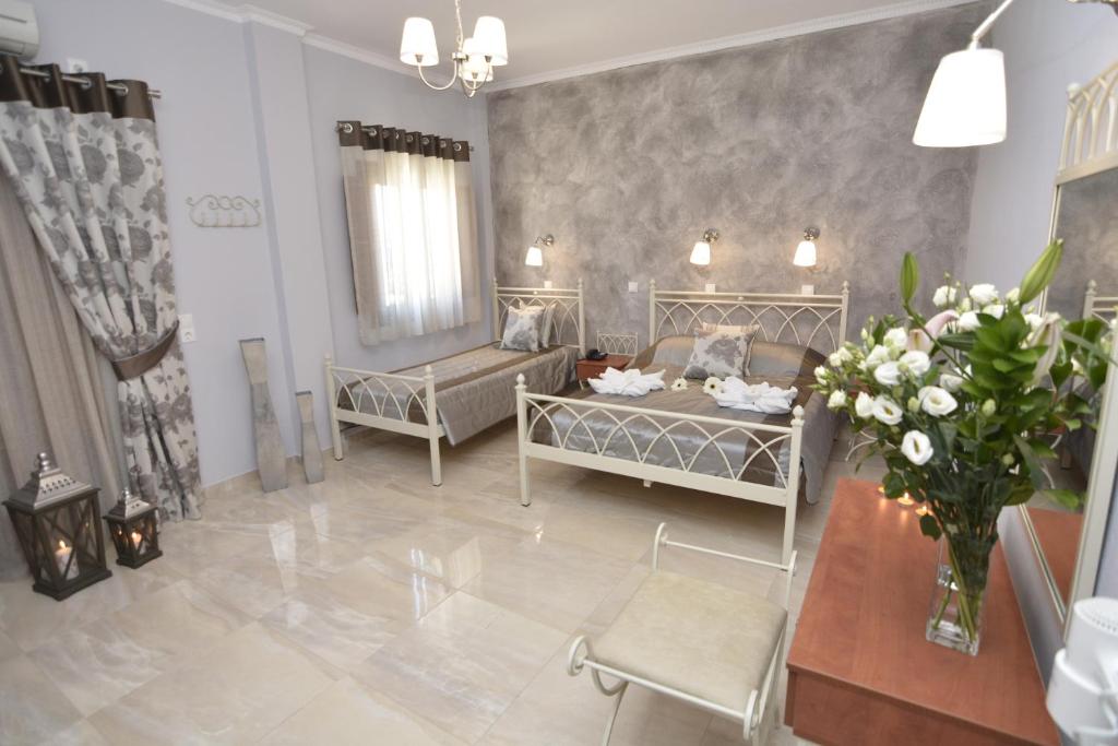 A bed or beds in a room at Polydefkis Hotel