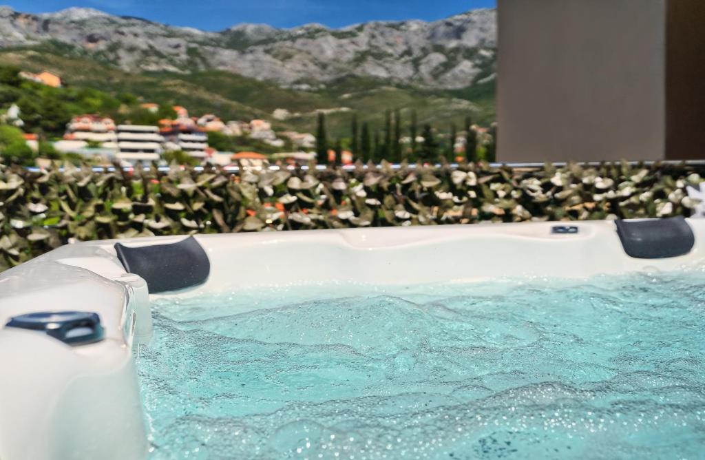 a hot tub with a view of a mountain at Relax apartment Split area with jacuzzi and mountain view in Žrnovnica