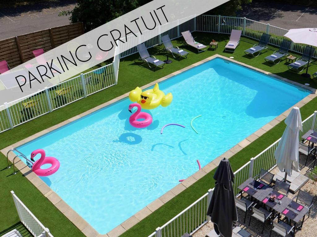 an overhead view of a swimming pool with swans and flamingos at Mercure Annemasse Porte De Genève in Gaillard