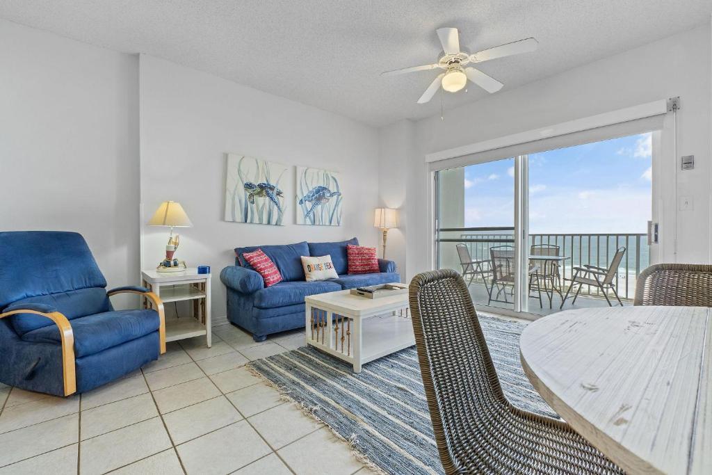 a living room with a couch and a table and chairs at Tidewater 503 in Orange Beach