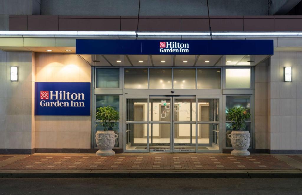 a building with two potted plants in front of it at Hilton Garden Inn Philadelphia Center City in Philadelphia