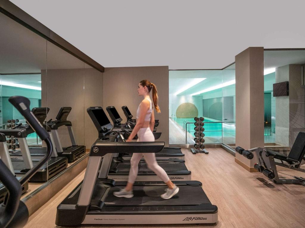a woman walking on a treadmill in a gym at Novotel Istanbul Bosphorus Hotel in Istanbul